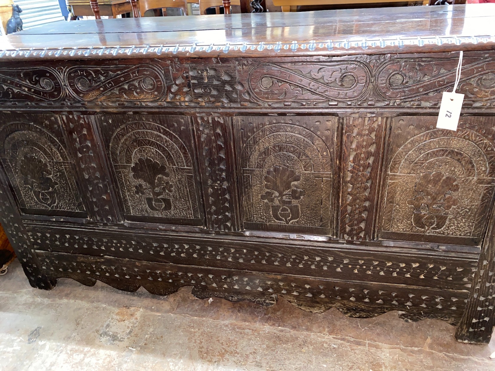 A 17th century carved oak coffer with adapted top, length 142cm, depth 56cm, height 76cm